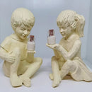 Creatieve hars tuinbeeld-Jongen en meisje standbeeld-decoratief tuinfiguur met glow in the dark poeder